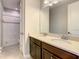 A bathroom featuring a double sink vanity with quartz countertops and a mirror, alongside a shower with a tub at 8491 Pippen Dr, Orlando, FL 32836