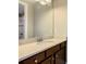 Bright bathroom showcasing a white speckled countertop and a large vanity mirror at 8491 Pippen Dr, Orlando, FL 32836