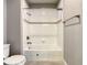 Bathroom featuring white tile and a decorative tile border above the bathtub at 8491 Pippen Dr, Orlando, FL 32836