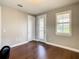 Neutral bedroom with hardwood floors and a door to a balcony at 8491 Pippen Dr, Orlando, FL 32836