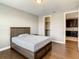 Clean bedroom with a simple bed and wood floors at 8491 Pippen Dr, Orlando, FL 32836