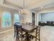 Open-concept dining room with modern lighting, tile flooring, and access to the living room at 8491 Pippen Dr, Orlando, FL 32836