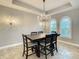 A well-lit dining room featuring an elegant chandelier and two arched windows at 8491 Pippen Dr, Orlando, FL 32836