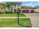 A beautiful home with a well-manicured lawn, landscaping, and an attached three-car garage at 8491 Pippen Dr, Orlando, FL 32836