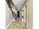 Grand entryway featuring a staircase with iron spindles, tile flooring, and abundant natural light at 8491 Pippen Dr, Orlando, FL 32836