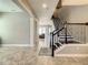 Open foyer with tile flooring, stairway with iron railing, and a view into the living room at 8491 Pippen Dr, Orlando, FL 32836