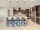Modern kitchen featuring a large island with seating, stainless steel appliances, and dark wood cabinets at 8491 Pippen Dr, Orlando, FL 32836