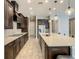 Modern kitchen with stainless steel appliances, a large island, and dark cabinetry at 8491 Pippen Dr, Orlando, FL 32836