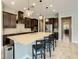 Spacious kitchen with a large center island, dark cabinetry, and modern stainless steel appliances at 8491 Pippen Dr, Orlando, FL 32836