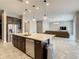 Open kitchen featuring a large island with seating, stainless steel appliances, and seamless living room access at 8491 Pippen Dr, Orlando, FL 32836