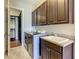 Well-equipped laundry room with modern machines, sink and ample counter space at 8491 Pippen Dr, Orlando, FL 32836
