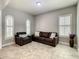 Cozy living room featuring tiled floors, three windows with shutters and comfortable seating at 8491 Pippen Dr, Orlando, FL 32836