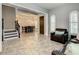 Spacious living room with staircase, tile flooring, and dining room access at 8491 Pippen Dr, Orlando, FL 32836