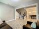 Open-concept living room and dining room, showcasing staircase with elegant black iron railing at 8491 Pippen Dr, Orlando, FL 32836