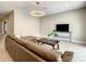 Cozy living room showcases a stylish chandelier, comfortable leather seating, and bright natural light at 8491 Pippen Dr, Orlando, FL 32836