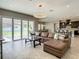 Spacious living room with sliding glass doors opening to the backyard, an open layout, and modern finishes at 8491 Pippen Dr, Orlando, FL 32836
