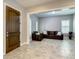 Elegant living room featuring tile floors, an arched window, and a cozy seating area at 8491 Pippen Dr, Orlando, FL 32836