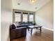 Cozy living room featuring hardwood floors, natural light from windows, and comfortable seating at 8491 Pippen Dr, Orlando, FL 32836
