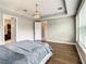 Bright main bedroom with tray ceilings, wood floors, and ensuite bathroom at 8491 Pippen Dr, Orlando, FL 32836