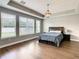 Comfortable main bedroom with hardwood floors, ample natural light, and a tray ceiling at 8491 Pippen Dr, Orlando, FL 32836