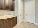 Well-organized mud room with tile flooring, ample cabinet space, and interior door access at 8491 Pippen Dr, Orlando, FL 32836