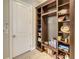 Organized mud room with shelving, tile flooring, and convenient access to interior door at 8491 Pippen Dr, Orlando, FL 32836