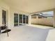 A covered outdoor patio with ample space for seating, featuring folding glass doors and access to the backyard at 8491 Pippen Dr, Orlando, FL 32836