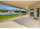 A covered outdoor patio with ample space for seating, offering a seamless transition to the well-maintained backyard at 8491 Pippen Dr, Orlando, FL 32836