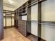 Large walk-in closet with custom shelving, drawers, and hanging space at 8491 Pippen Dr, Orlando, FL 32836
