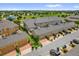 Aerial view of townhomes with attached garages and a community playground in the distance at 8500 Iron Mountain Trl, Windermere, FL 34786