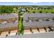 Aerial view of townhomes with attached garages, manicured lawns, and a community park at 8500 Iron Mountain Trl, Windermere, FL 34786