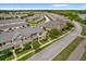 Aerial view of residential community with lush landscaping, sidewalks, and a tranquil lake nearby at 8500 Iron Mountain Trl, Windermere, FL 34786