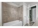Bathroom featuring neutral tile shower/tub combination, adding modern functionality to the space at 8500 Iron Mountain Trl, Windermere, FL 34786