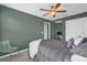Bedroom with plaid bedding, green walls, and a window offering natural light at 8500 Iron Mountain Trl, Windermere, FL 34786