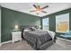 Bedroom with plaid bedding, green walls, and multiple windows offering natural light at 8500 Iron Mountain Trl, Windermere, FL 34786