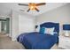 Bedroom featuring bright blue bedding, a ceiling fan and a closet for storage at 8500 Iron Mountain Trl, Windermere, FL 34786