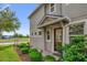 Inviting home exterior with a covered entryway and lush landscaping, showcasing its curb appeal at 8500 Iron Mountain Trl, Windermere, FL 34786