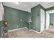 Upstairs hallway with neutral carpet and a decorative plant on a glass table at 8500 Iron Mountain Trl, Windermere, FL 34786