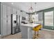 Modern kitchen with stainless steel appliances, stylish pendant lighting, and a functional center island at 8500 Iron Mountain Trl, Windermere, FL 34786