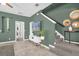 Inviting living room with staircase, stylish decor, and neutral tile flooring at 8500 Iron Mountain Trl, Windermere, FL 34786