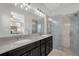 Modern main bathroom with double vanity, granite countertops, and glass-enclosed shower at 8500 Iron Mountain Trl, Windermere, FL 34786