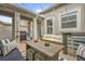 Cozy covered patio with outdoor seating, BBQ grill, and decorative lighting at 8500 Iron Mountain Trl, Windermere, FL 34786