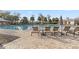 Community pool with lounge chairs and umbrellas for poolside relaxation on a sunny day at 8500 Iron Mountain Trl, Windermere, FL 34786