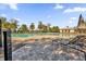 Community pool with lounge chairs and umbrellas for relaxation by the poolside at 8500 Iron Mountain Trl, Windermere, FL 34786