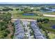 Aerial view of houses next to a large golf course with water features at 8807 Interlocking Ct, Davenport, FL 33896