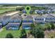 An aerial view of backyard pools, the golf course and neighboring houses at 8807 Interlocking Ct, Davenport, FL 33896