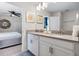 Bathroom with double sink, neutral decor, and bedroom view at 8807 Interlocking Ct, Davenport, FL 33896