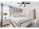 Comfortable bedroom with neutral color scheme, mirrored furnishings, and plenty of light at 8807 Interlocking Ct, Davenport, FL 33896