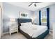 Cozy bedroom with a tufted headboard bed, stylish decor, and an abundance of natural light at 8807 Interlocking Ct, Davenport, FL 33896