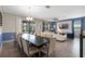 Spacious dining area with a large table and chairs, open to the living room with abundant natural light at 8807 Interlocking Ct, Davenport, FL 33896
